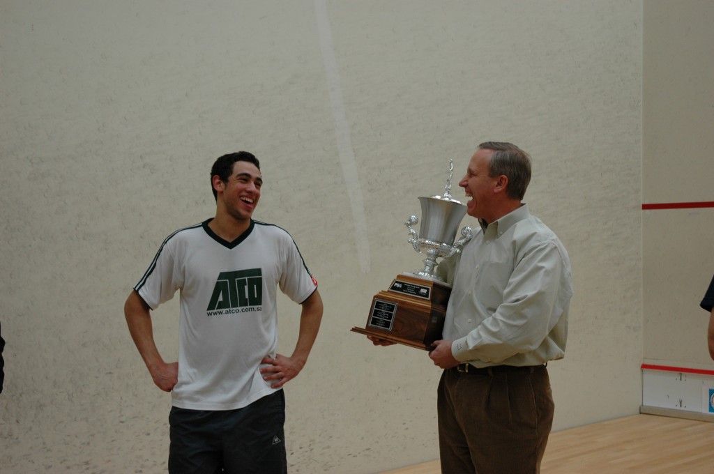 pearly whites Ramy Ashour flashes his trademark smile as Rob Suttman, of EBS Asset Management, presents him with yet another trophy.