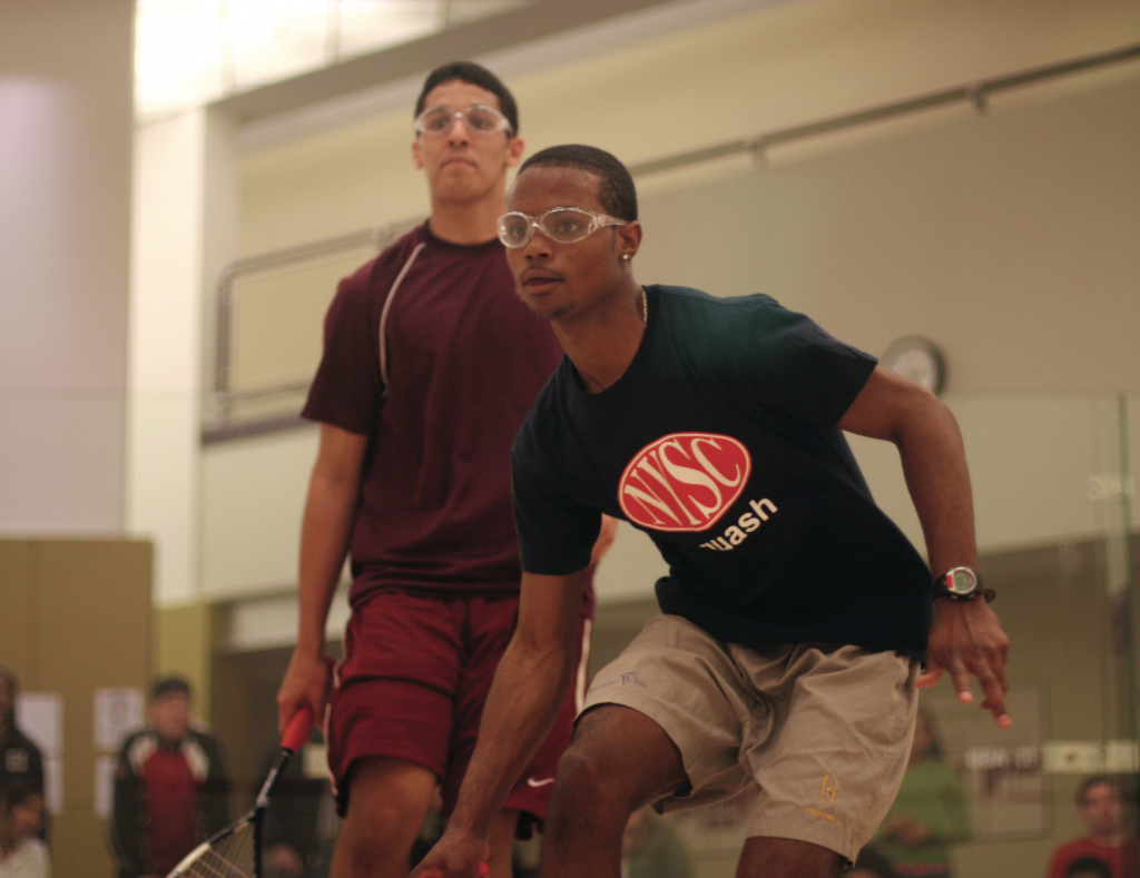 Pedro Souza of SquashBusters (L) and David Nash of StreetSquash keep their eyes on the ball in the battle of the number ones in the BU19 team final.