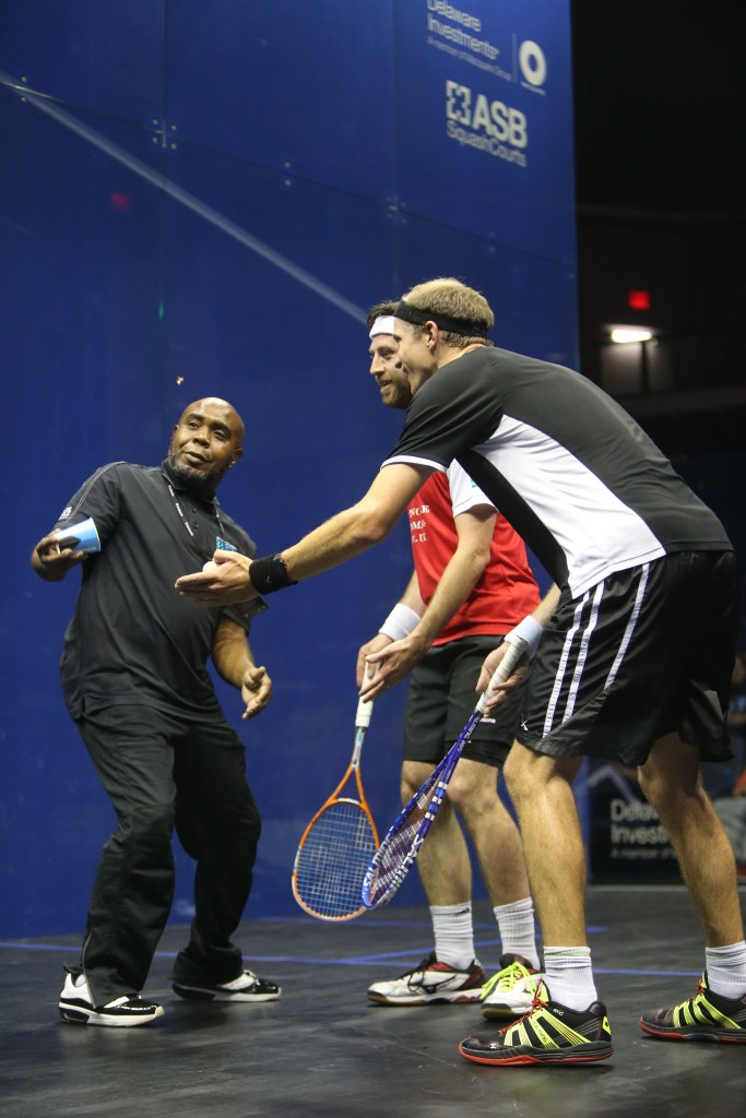In perhaps a first for squash, play was disrupted by a moth fluttering on court. After Stephen Coppinger (r) and Daryl Selby (m) failed to corral the creature, court attendant Gary Reed (l) gathered it in a cup and escorted it to safety.  