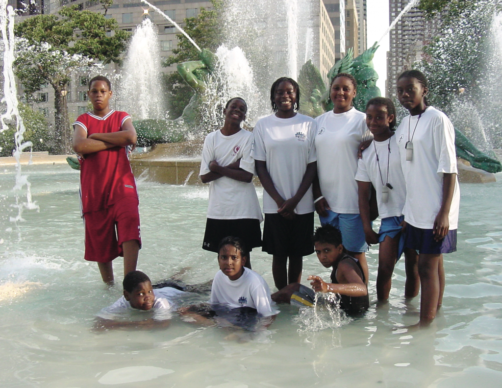 MORE THAN JUST SQUASH SquashSmarts students capped a grueling five-day Outward Bound summer expedition in the fountain at Philadelphia’s Logan Circle. (L-R, standing): Demonte Harris, Donte Lambert, Tempest Bowden, Jasmine Wingate, Brittany Kennedy, Quinetta Bowden. (laying down): Devonte Harris, Mithun Das and Junaid Bin Mukhtar.