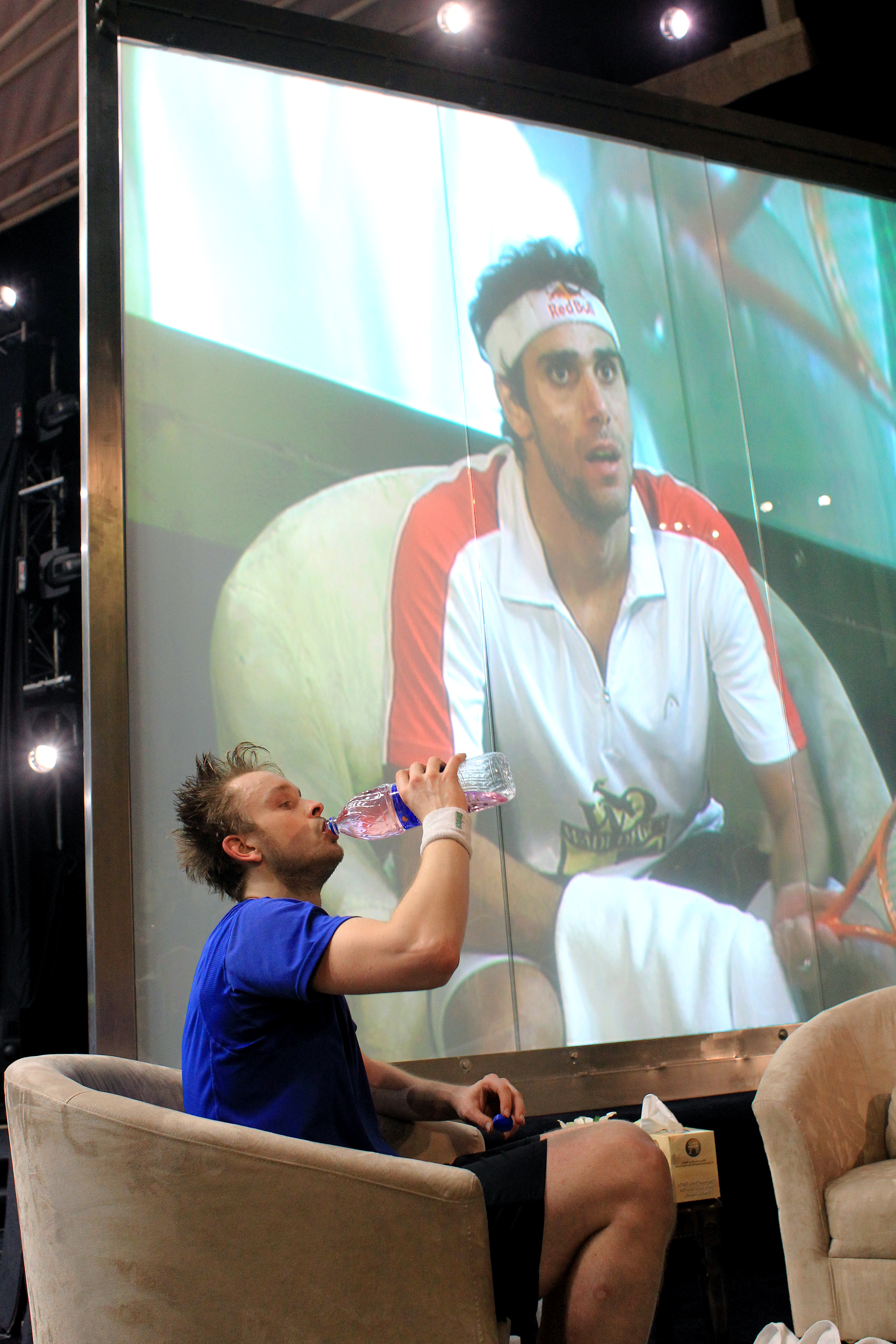 With all the trappings of a world class event, James Willstrop gathers himself between games in comfy lounge chairs, with giant screens on either side of the court catching Karim Darwish doing the same. 