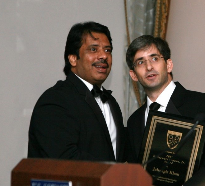 Kevin Klipstein (R), CEO of U.S. SQUASH, and Jahangir Khan look at the montage of images from Khan’s illustrious career on the giant video screen before Klipstein presented him with the 2008 W. Stewart Brauns Award for administrative leadership.