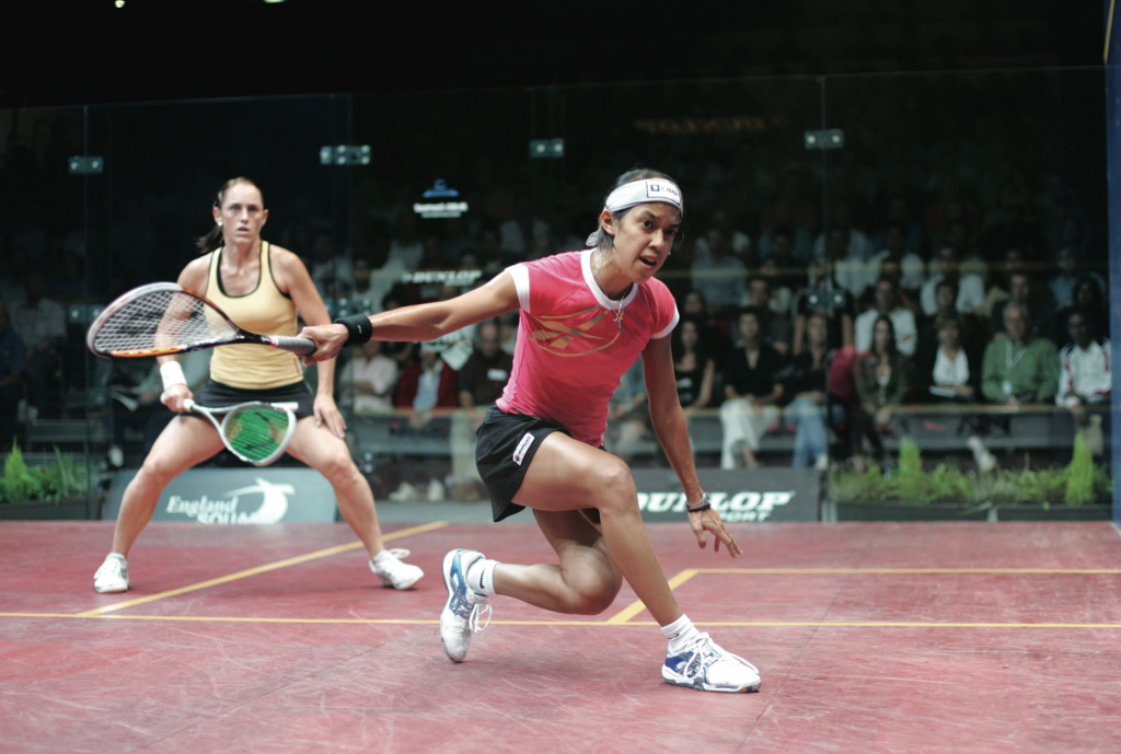 Rachael Grinham (L) is not “at the T,” but she is positioned at the center of Nicol David’s available shot options (in this case, behind the T)–which will enable her to cover them all.
