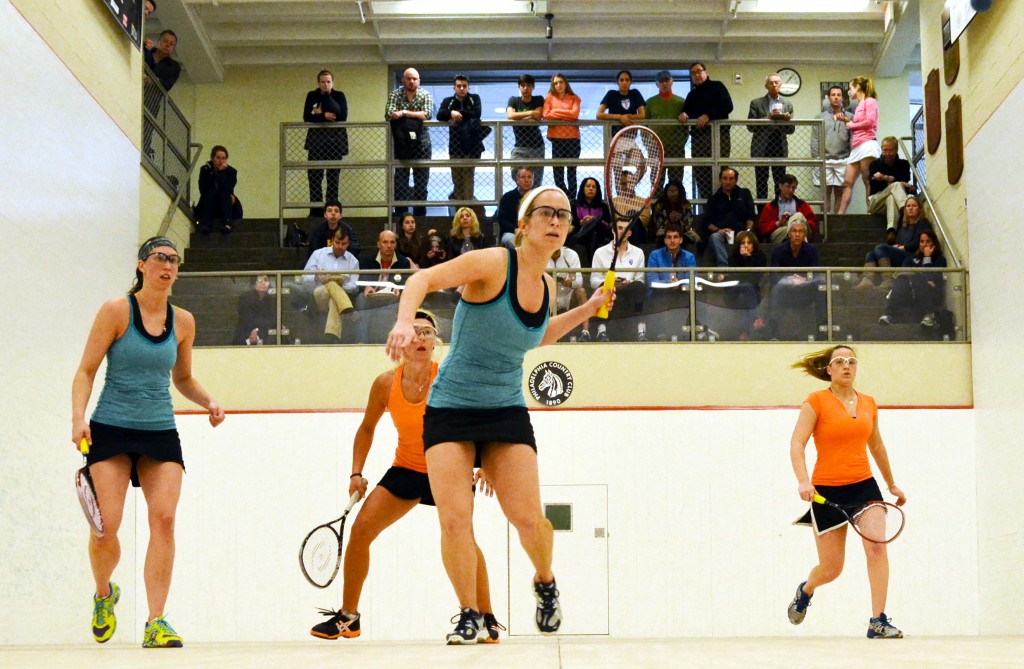 Playing on the same court on which they reached the 2013 U.S. Open Doubles final as qualifiers, Philadelphia’s Amy Gross (center) and Alexandra Clark (far left) reached another final at PCC. The PCC logo visible in back court bears a Horse’s head, which originated with the club being founded with a Polo field in 1890. 